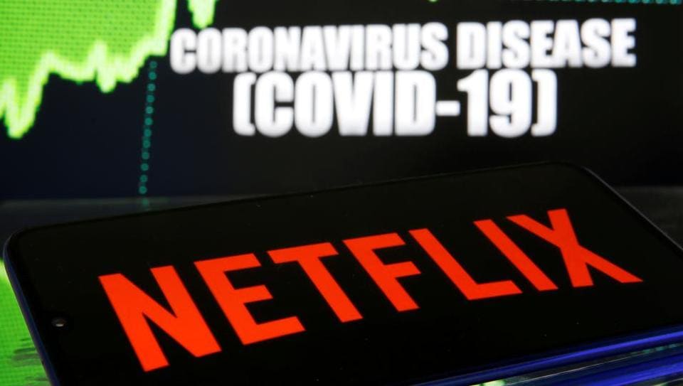 Netflix logo is seen in front of diplayed coronavirus disease (COVID-19) in this illustration taken March 19, 2020.