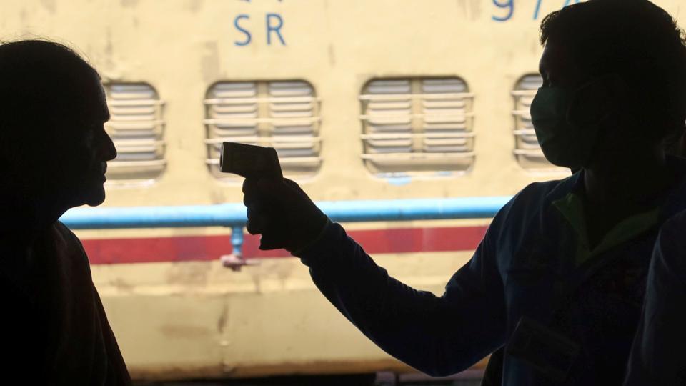 Kozhikode: Health Department officials use infrared thermometers to examine passengers in the wake of coronavirus pandemic at a railway station in Kozhikode, Saturday, March 21, 2020. Novel coronavirus cases in India rose to 258 on Saturday after 35 fresh cases were reported in various parts of the country. (PTI Photo) (PTI21-03-2020_000094B)