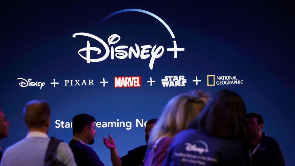 Attendees sign up for the Disney+ streaming service during the D23 Expo 2019 in Anaheim, California, U.S., on Friday, Aug. 23, 2019. Walt Disney Co. is turning the D23 Expo, the biennial fan conclave, into a big push for its new streaming services.
