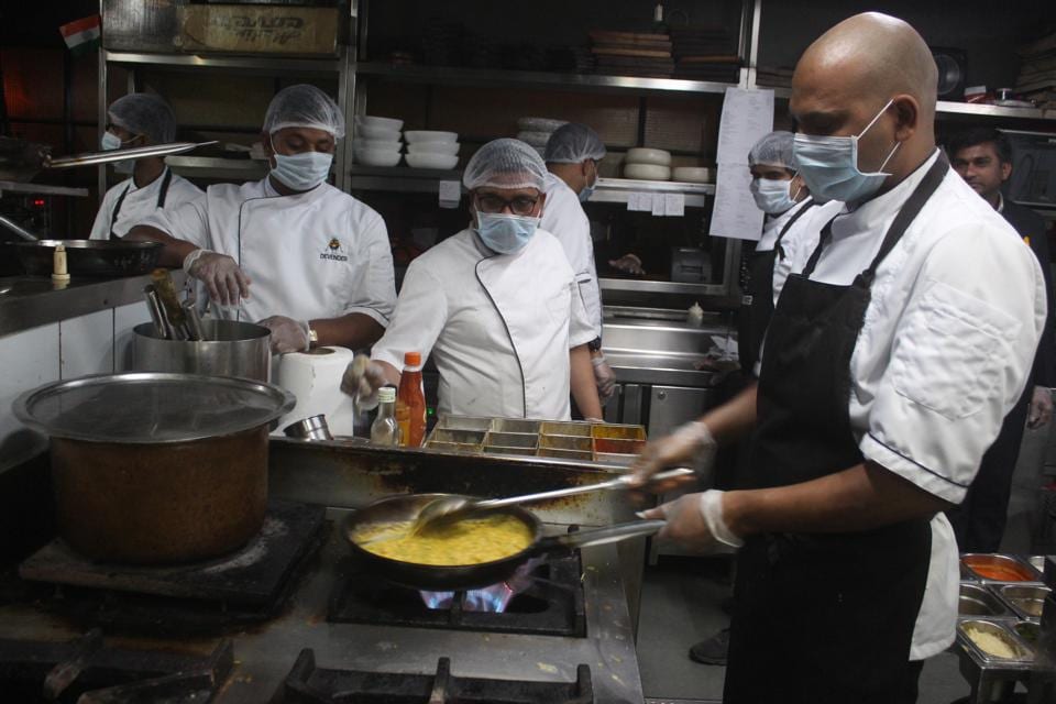 Gurugram, India- March 13, 2020: Kitchen staff prepare food wearing protective masks amid rising coronavirus scare at Prankster Restaurant pub and bar, Sector 29 in Gurugram, India, on Friday, March 13, 2020. (Photo by Yogendra Kumar/Hindustan Times)
