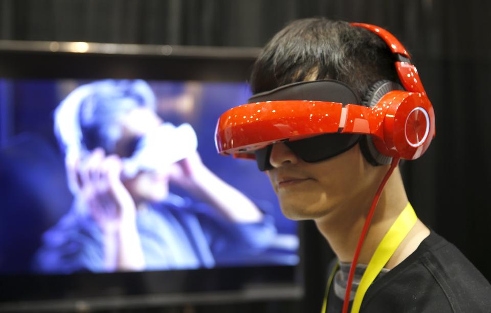 (Representational photos) Eric Yu of Royole models the company's foldable Smart Mobile Theater system during 