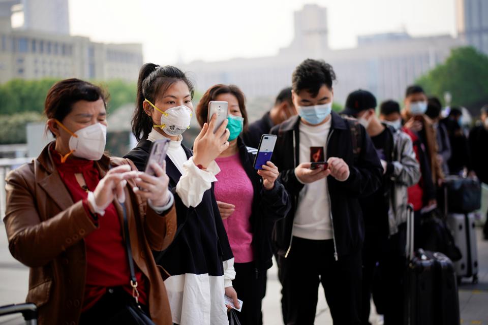 People wait for the train at the Hankou Railway Station in Wuhan as travel restrictions for leaving the city, the epicentre of a global coronavirus disease (COVID-19) outbreak, are lifted and people will be allowed to leave the city via road, rail and air, in Wuhan, Hubei, China April 8, 2020. REUTERS/Aly Song