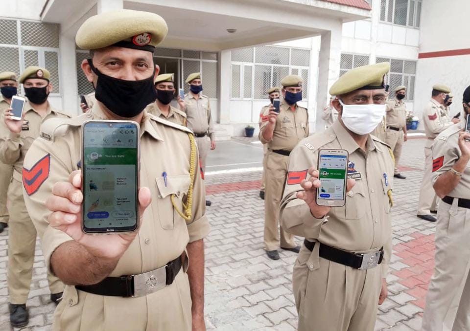 Jammu and Kashmir, Apr 22 (ANI): J&K police personnel display Aarogya setu aap after installing on their mobile phones, in Reasi on Wednesday.