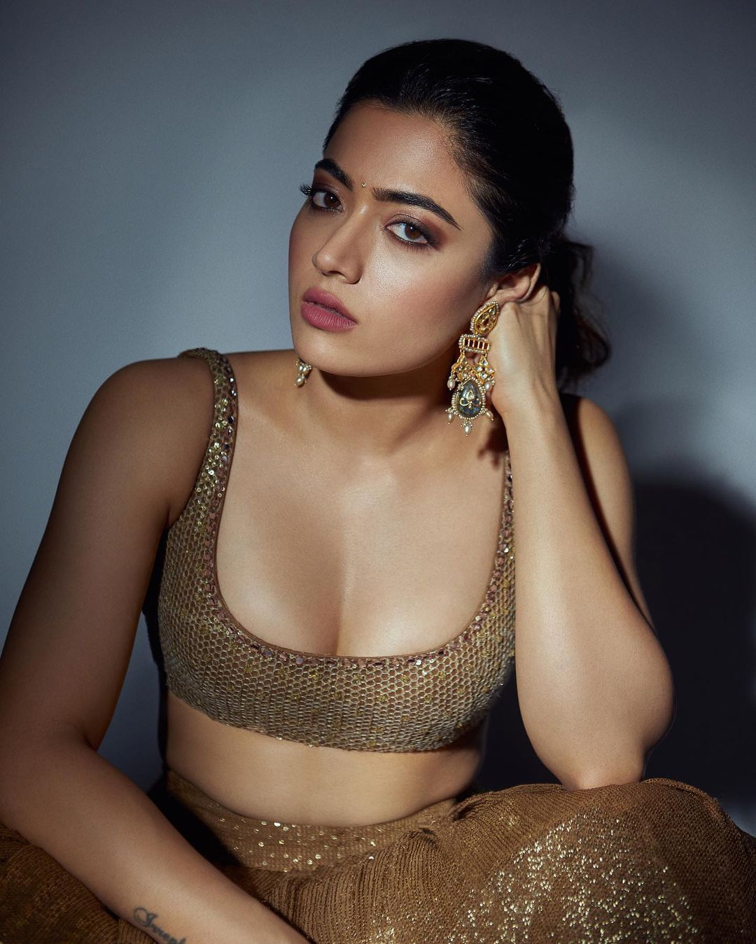 Rashmika Madanna in Golden Lehenga: రోజురోజుకూ తన హాట్‌నెస్‌ డోసు పెంచుతోంది రష్మిక మందన్నా. తాజాగా గోల్డెన్‌ లెహంగాలో ఆమె కెమెరాకు పోజులిచ్చింది. ఈ ఫొటోల్లో ఆమె చాలా హాట్‌గా కనిపించింది.