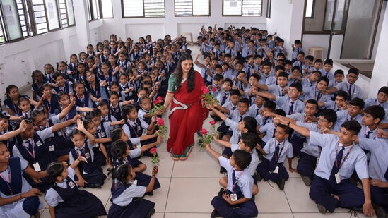  Surat: Students give flowers to their teacher on the occasion of Guru Purnima festival, in Surat, Saturday, July 1, 2023. (PTI Photo)  (PTI07_01_2023_000061B)